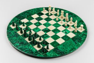 A 20TH CENTURY MALACHITE AND MARBLE CIRCULAR CHESS SET WITH BRONZE INLAY TO BOARD. One pawn missing.