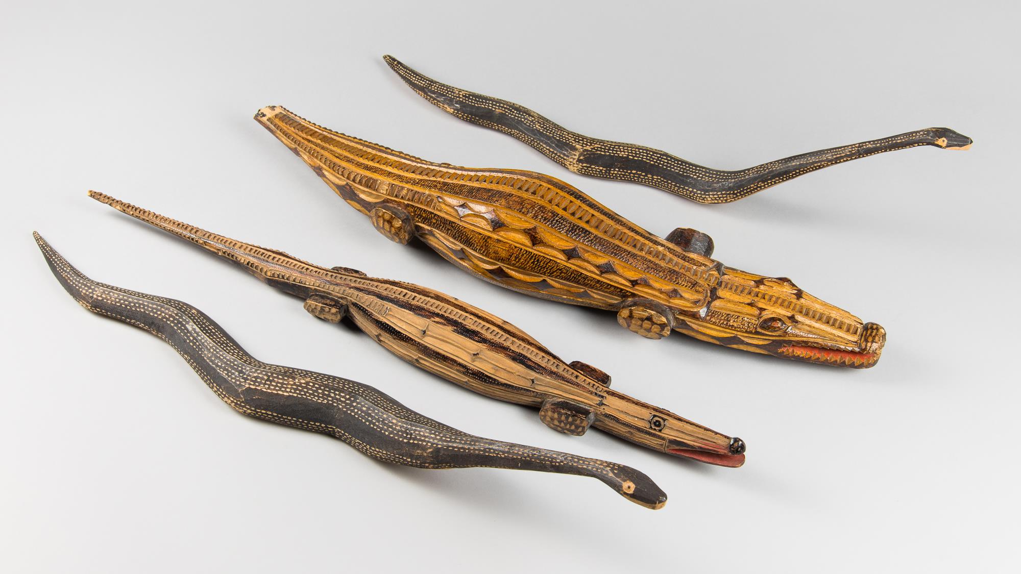FOUR MID 20TH CENTURY AFRICAN TRIBAL ART CARVINGS OF TWO CROCODILES AND TWO SNAKES. Both