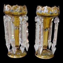 A PAIR OF VICTORIAN AMBER GLASS LUSTRES Having a scrolled edge, hand painted floral decoration and