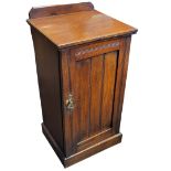 AN EDWARDIAN WALNUT POT CUPBOARD Along with mahogany fretwork open shelves, partial glazed table top