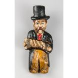 AN EARLY 20TH CENTURY FOLK ART MUSICIAN FIGURE. Carved oak figure of a musician playing a concertina