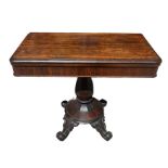 A 19TH CENTURY ROSEWOOD FOLD OVER TEA TABLE Supported on bulbous column, terminating on four