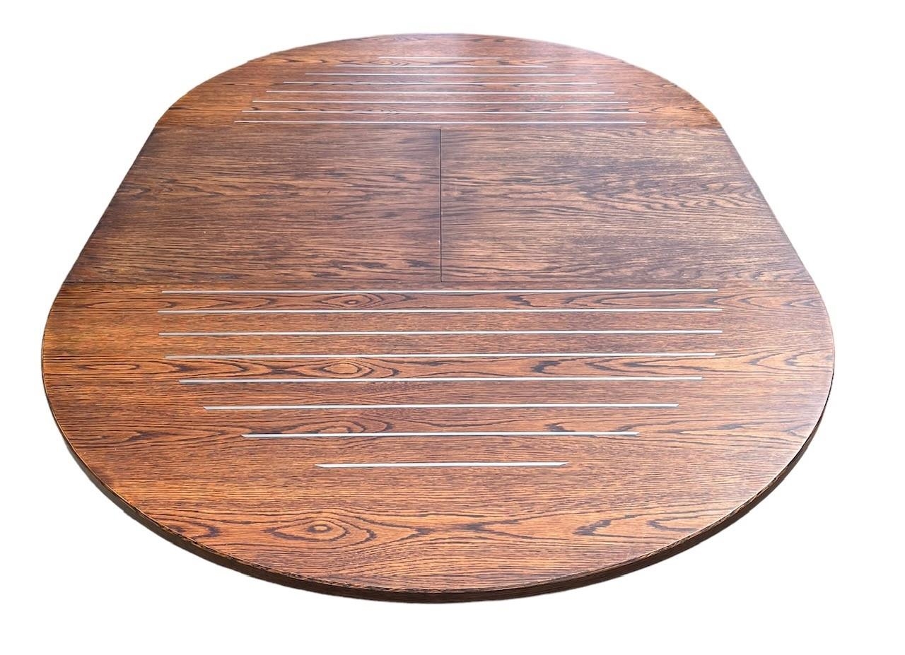 A CONTEMPORARY OAK AND STEEL INLAY DRAW LEAF DINING TABLE With single leaf, together with a matching - Image 3 of 7