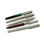 A PARKER FRONTIER FOUNTAIN PEN, TOGETHER WITH FOUR STEEL PARKER PENS. (5)