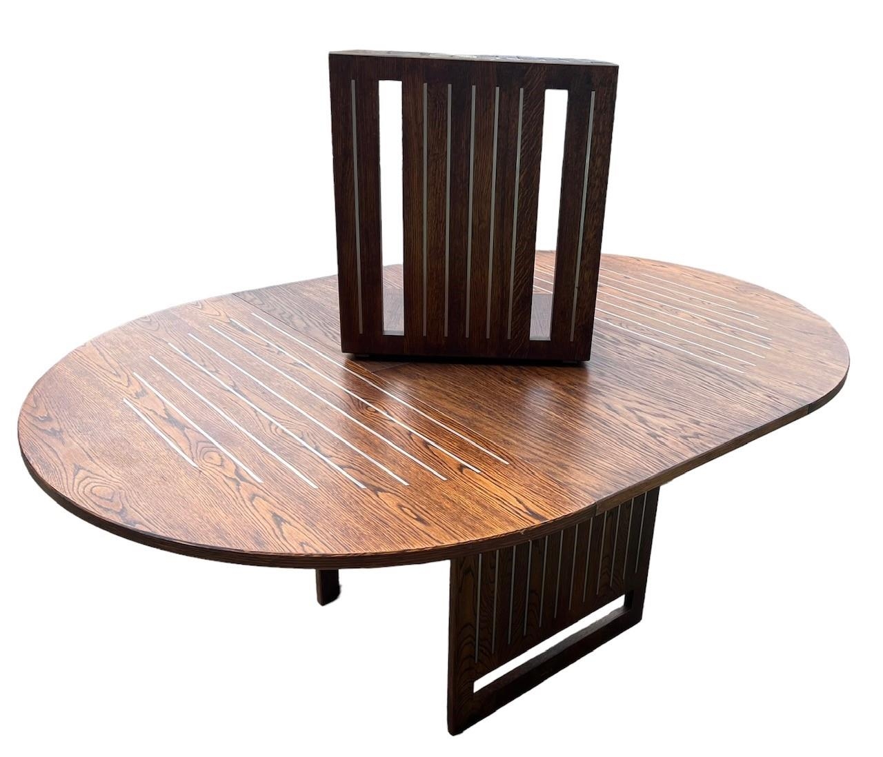 A CONTEMPORARY OAK AND STEEL INLAY DRAW LEAF DINING TABLE With single leaf, together with a matching - Image 6 of 7