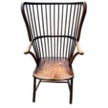 AN UNUSUAL 19TH CENTURY WINDSOR STICK BACK ARMCHAIR The turned spindles above solid shaped seat,