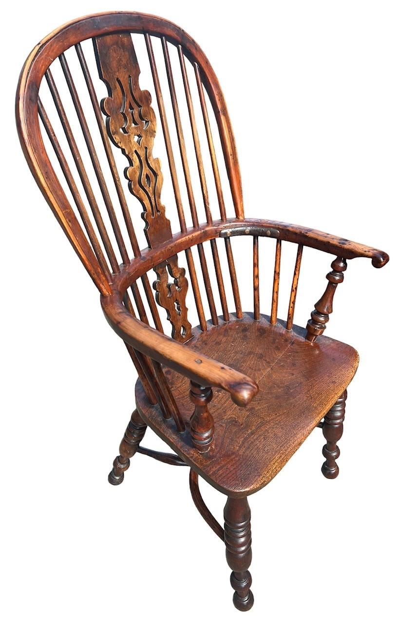 A 19TH CENTURY YEW WOOD AND ELM WINDSOR CHAIR The pierced splat and turned spindles above a solid