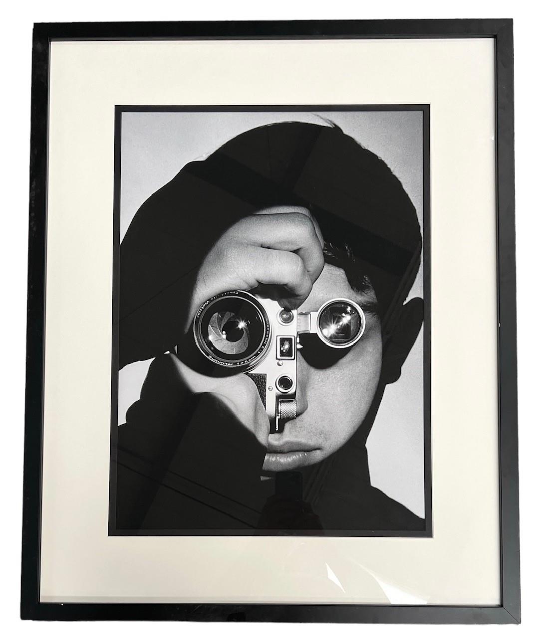 A DECORATIVE BLACK AND WHITE PRINT Portrait of photographer, framed and glazed. (70cm x 87cm)