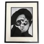 A DECORATIVE BLACK AND WHITE PRINT Portrait of photographer, framed and glazed. (70cm x 87cm)