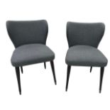 A PAIR OF CONTEMPORARY UPHOLSTERED WINGBACK CHAIRS Raised on ebonised legs. (h 85cm x d 46cm x w
