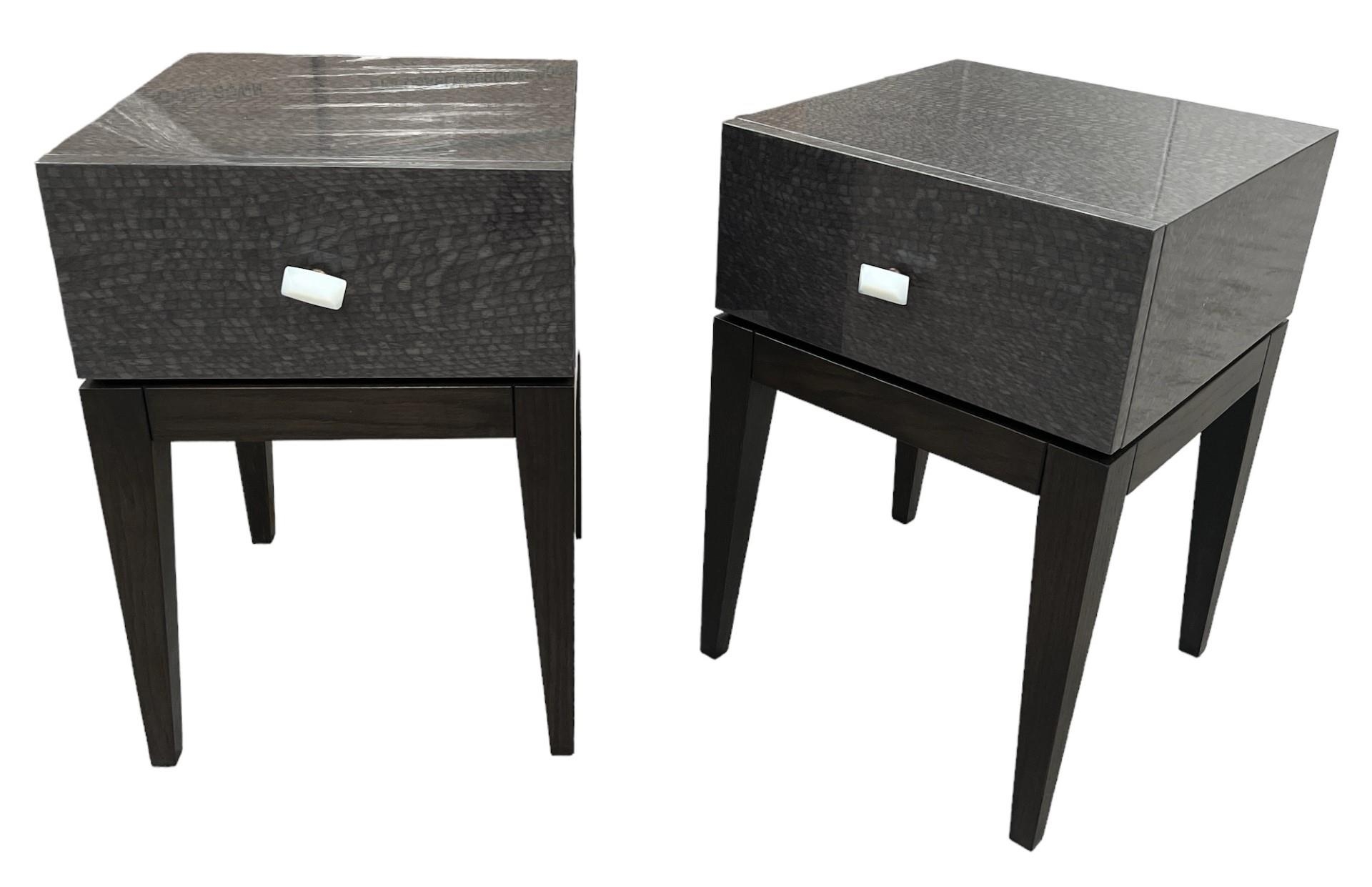 A PAIR OF CONTEMPORARY FAUX LEATHER LACQUERED SINGLE DRAWER BEDSIDE TABLE Raised on square