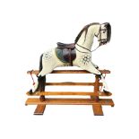 ROCKING HORSE SHOP, A LARGE DECORATIVE CARVED WOOD DAPPLED ROCKING HORSE, with glass eyes leather