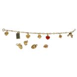 A VINTAGE 9CT GOLD CHARM BRACELET HAVING 9CT AND 14CT CHARMS, HALLMARKED WITH IMPORT MARKS FOR