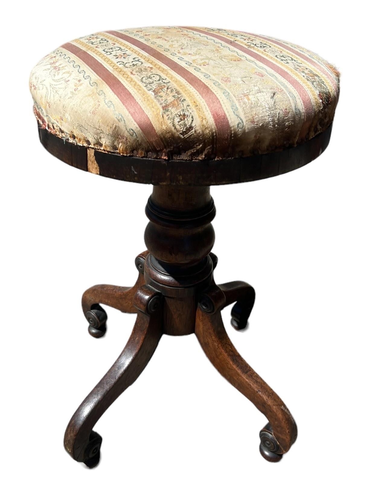 A 19TH CENTURY MAHOGANY PIANO STOOL With circular adjustable seat, raised on four scrolling legs. (h
