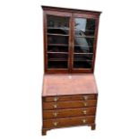 AN 18TH CENTURY MAHOGANY BUREAU BOOKCASE With two glazed doors with shelves interior above