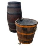 A 19TH CENTURY OAK AND IRON BROUND BARREL STICK STAND Together with a 19th Century Regency barrel