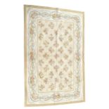 A 20TH CENTURY AUBUSSON FRENCH STYLE CREAM COLOURED RUG Having geometric floral motif contained in a