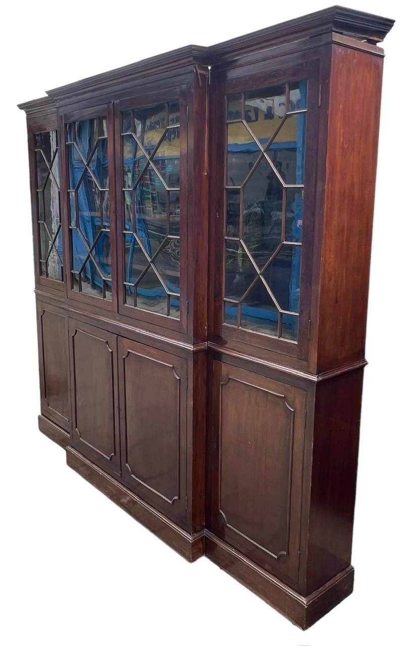 AN EARLY LARGE 19TH CENTURY MAHOGANY BREAKFRONT BOOKCASE With four aster glazed doors opening to - Image 2 of 3