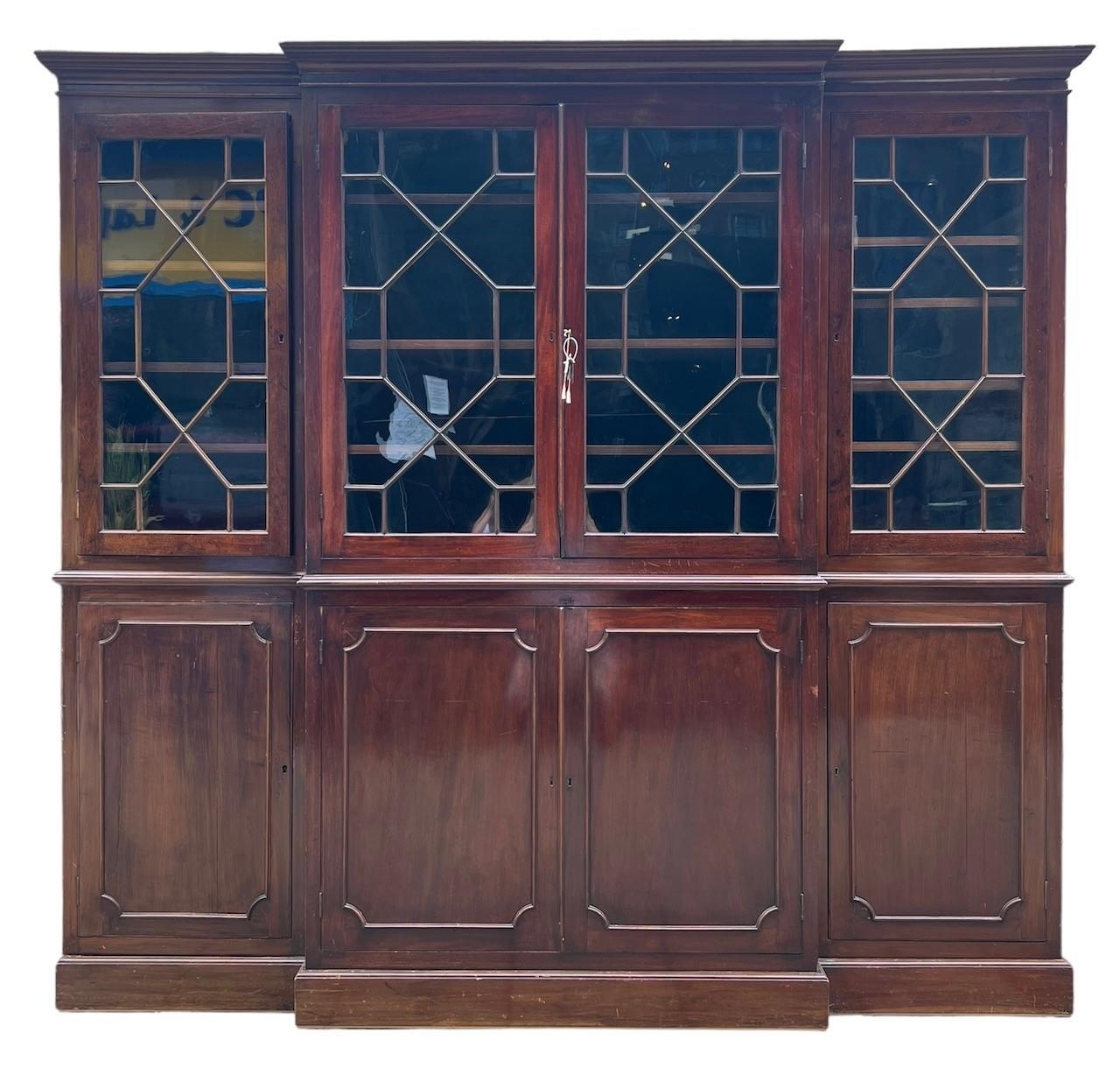 AN EARLY LARGE 19TH CENTURY MAHOGANY BREAKFRONT BOOKCASE With four aster glazed doors opening to - Image 3 of 3