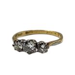 AN 18CT GOLD AND DIAMOND THREE STONE RING Having a single row of round cut diamonds. (approx total