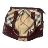 BURBERRY, A VINTAGE PATENT LEATHER AND FABRIC BARREL HANDBAG Having burgundy leather trim and fitted