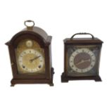 A 20TH CENTURY MAHOGANY AND BRASS MANTLE CLOCK Having a single carry handle, arched brass dial,