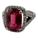 AN 18CT WHITE GOLD, PINK TOURMALINE AND DIAMOND RING The central oval cut stone edged with diamonds.