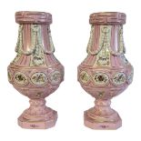 A PAIR OF CONTINENTAL BALUSTER PORCELAIN VASES With classical applied swags, floral decoration on