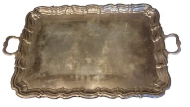 A LARGE EDWARDIAN SILVER BUTLER’S TRAY Having twin handles and scrolled edge, hallmarked Jay