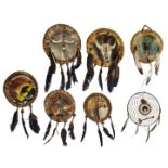 A COLLECTION OF SIX VINTAGE NATIVE AMERICAN ANIMAL SKIN AND FEATHER CIRCULAR SHIELDS Hand painted