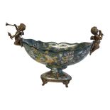 A CONTINENTAL PORCELAIN AND ENAMELLED COMPORT Mounted with two bronze musician cherubs, decorated