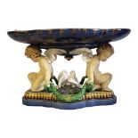 A HIGH VICTORIAN MINTON MAJOLICA CHERUBS AND DOVE COMPORT TAZZA Impressed year cypher 1861, the