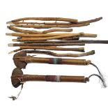 TWO VINTAGE NATIVE AMERICAN STONE CLUB AXES Leather clad with applied beadwork, together with twelve