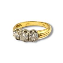 AN 18CT GOLD AND DIAMOND THREE STONE RING Arrow of round cut diamonds. (approx total weight .60ct,