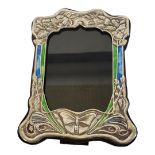AN ART NOUVEAU STYLE PICTURE FRAME With enamel and floral embossed metal facade on a wooden easel