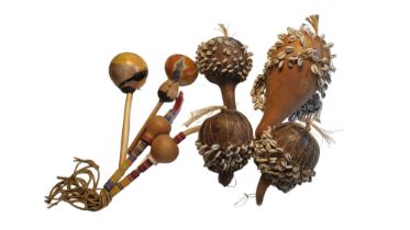 A COLLECTION OF FOUR VINTAGE AFRICAN GOURD AND COWRIE SHELL CEREMONIAL RATTLES Three having