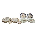 A SET OF TEN EDWARDIAN COPELAND CHINA DESSERT PLATES Painted with scattered flowers reserved on a