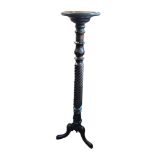 A REGENCY STYLE MAHOGANY TORCHÈRE The circular top raised a tulip and candy twist column standing on