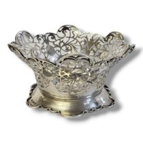 AN EDWARDIAN SILVER CIRCULAR SWEETMEAT BASKET With scrolled edge and pierced decoration,