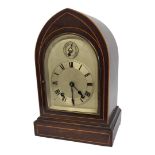 A LATE 19TH CENTURY GOTHIC MAHOGANY AND BOXWOOD INLAID CLOCK With silvered dial and chiming