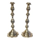 A PAIR OF 20TH CENTURY SILVER CANDLESTICKS Having engraved decoration and scrolled base. (approx