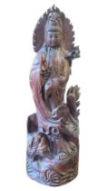 A LARGE TRADITIONAL HARDWOOD CARVING OF THE CHINESE GODDESS GUANYIN Holding a water sprinkler and