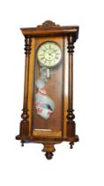 A 19TH CENTURY MAHOGANY VIENNA WALL HANGING CLOCK With white enamelled dial, pendulum and