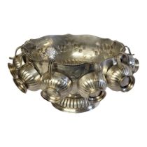 A LARGE 20TH CENTURY SILVER PLATE ON COPPER PUNCH BOWL AND CUPS Having a gadrooned border,lion