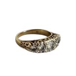 AN EARLY 20TH CENTURY 18CT GOLD AND DIAMOND FIVE STONE RING The arrangement of graduated round