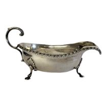 A PAIR OF VICTORIAN SILVER SAUCE BOATS With gadrooned border, single handle and tripod legs,