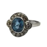 A VINTAGE 18CT WHITE GOLD, AQUAMARINE AND DIAMOND RING Having oval cut central stone edged with