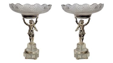 A PAIR OF SILVER PLATE AND CUT LEAD CRYSTAL GLASS FIGURAL TAZZAS Having hobnail cuts to glass,