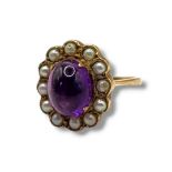 A VINTAGE 9CT GOLD, AMETHYST AND SEED PEARL RING Cabochon cut oval amethyst edged with seed
