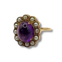 A VINTAGE 9CT GOLD, AMETHYST AND SEED PEARL RING Cabochon cut oval amethyst edged with seed